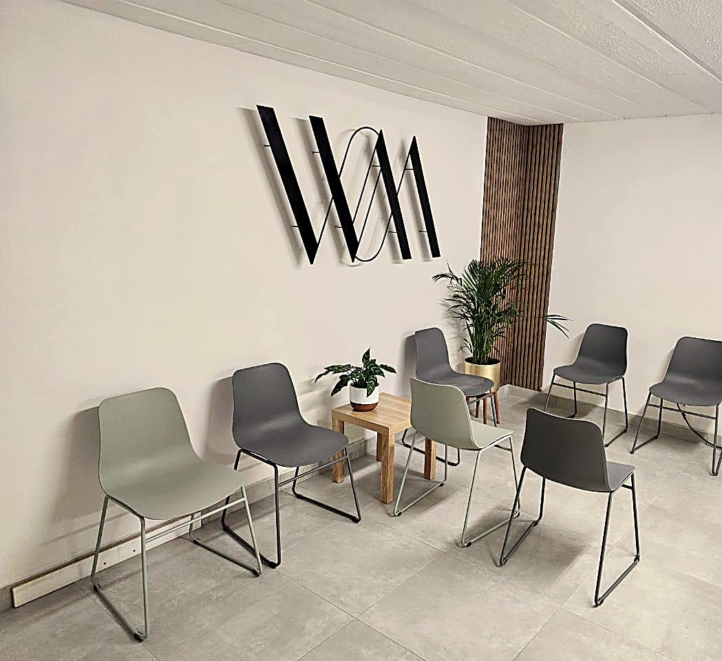 The WillowMed waiting area: soft green chairs, warm oak and natural light